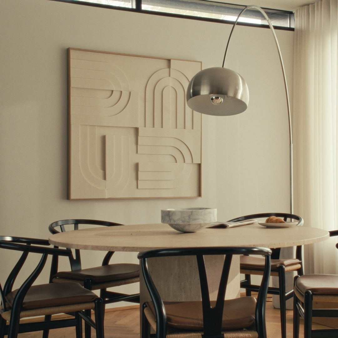 Beige Arturel X Kvadrat akustikpanel i elegant egetræsramme monteret på væggen over et rundt spisebord
